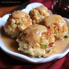 some food is sitting on a white plate with gravy and ketchup