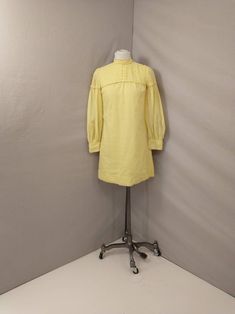 "Beautiful authentic 1960's mini dress. Super feminine period style. Quality construction with sheer overlay, Pintuck detailing at shoulders. Clear lemon yellow. No size tag, shown on a 6 mannequin, please go by measurements. Metal zipper back. Two layers except sleeves. Very good condition, no damage, light spot at neck some light rust marks from a hanger inside only. Length 33\" Shoulders 14.5\" Bust 36\" Waist 36\" Hips 38\" Hem circumference is 45\" Wt 8oz" 1970s Style Yellow Spring Dress, Vintage Yellow Puff Sleeve Dress, Vintage Knee-length Spring Mini Dress, Vintage Long Sleeve Mini Dress For Daywear, Vintage Knee-length Mini Dress For Spring, Retro Mini Dress For Spring Daywear, Vintage Long Sleeve Mini Dress For Spring, Knee-length Retro Mini Dress For Daywear, Retro Knee-length Mini Dress For Daywear