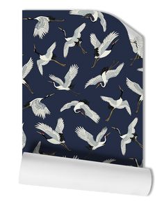 a blue wallpaper with white cranes on it