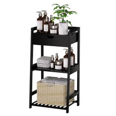 a shelf with some bottles and soaps on top of it next to a potted plant