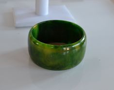 STATEMENT wide Art Deco end of day marbled green yellow bangle bracelet vintage tested  - tested with simichrome  2.5 inches inner diameter; 1/4 inches width; 1.5 inches tall good condition with some fine surface scratches - sold as is. Thank you for watching my other items! a huge collection of plastic jewelry is listed and much more to come! Combined shipping available where possible -please contact us for details before buying the items. Unique Green Cuff Bracelet Bangle, Unique Green Cuff Bangle Bracelet, Unique Green Round Bangle, Handmade Green Round Cuff Bracelet, Unique Green Bangle Cuff Bracelet, Wide Art, Plastic Gift Wrap, Yellow Costume, Bakelite Bangles