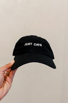 Just Cats embroidered black hat with white writing. Embroidered in Los Angeles, CA. PIPE AND ROW Casual Cat-ears Hat With Cat Design, Black Cotton Hat With Letter Embroidery, Black Cat Ears Hat With Cat Design, Black Cat Design Hat With Cat Ears, Black Hat With Cat Ears And Cat Design, Casual Cat Design Hat, One Size Fits Most, Trendy Black Hat With Letter Embroidery, Trendy Adjustable Hat With Cat Design, Trendy Adjustable Cat Design Hat