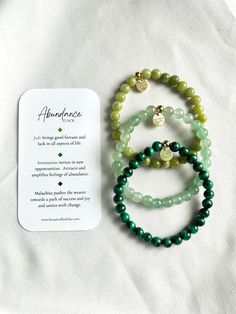 The abundance stack was created with the intention of attracting and inviting prosperity, wealth, and success into your life. Each of these gemstones carry a unique healing energy that assists with manifesting a dream life. These stones draw in opportunity, success, and abundance in regards to relationships, finances, career, and any other aspect of life. Whether you want to get rich with money or vibes, this is the stack for you. The energy exuding from these stones wants you to WIN.   Your purchase includes 3 bracelets, an information card highlighting some of the stones best qualities and healing abilities, and a satin pouch for storing. Bracelets include: - Jade Stacker - Aventurine Stacker -Malachite Stacker   Bracelets are composed of a sturdy, stretch elastic string, measuring appro Spiritual Green Malachite Beaded Bracelets, Green Malachite Spiritual Beaded Bracelets, Spiritual Jade Beaded Bracelets For Everyday, Spiritual Malachite Bracelets As Gift, Spiritual Malachite Bracelet As A Gift, Everyday Spiritual Jade Beaded Bracelets, Green Malachite Beaded Bracelets As Gift, Green Malachite Beaded Bracelet As Gift, Holistic Jade Jewelry For Meditation