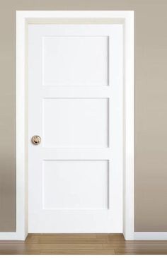 an open white door in a room with hardwood floors and walls, showing the bottom part of