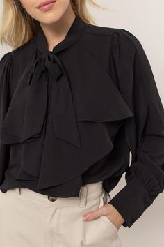 Get ready to add some playful flair to your wardrobe with our Ruffles Blouse! Featuring long balloon sleeves with buttoned cuffs, a pretty tie-neck, and gentle ruffles at the front, this blouse brings fluttery movement to any outfit. The button-down bodice offers a classic fit and ends with a rounded hem for a stylish touch. 100% Polyester Chic Formal Blouse With Ruffle Sleeves, Chic Ruffled Office Blouse, Chic Office Blouse With Ruffles, Office Blouse With Ruffled Collar And Ruffles, Elegant Blouse With Ruffle Hem, Long Sleeve Ruffled Blouse For Work, Chic Ruffled Tie Neck Top, Ruffled Long Sleeve Blouse For Office, Ruffled Collar Blouse For Work