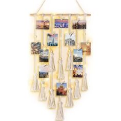 a wall hanging with pictures and tassels attached to the side on a white background