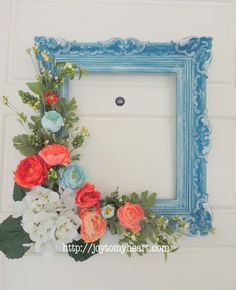 a blue frame decorated with flowers and greenery