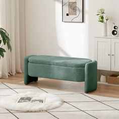 a green bench sitting on top of a white rug in a living room next to a window