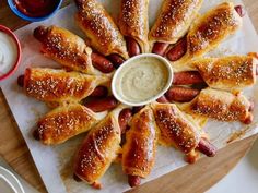 hotdogs wrapped in bread with dipping sauce