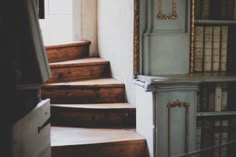 a room with some stairs and bookshelves in it