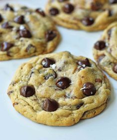 several chocolate chip cookies on a white plate