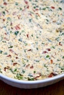 a casserole dish with cheese and vegetables in it sitting on a table top