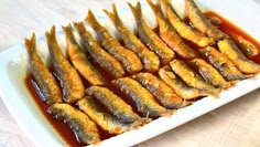 an image of fried fish in sauce on a plate