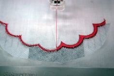 a piece of cloth with red thread on it