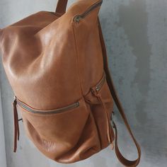 This stunning backpack is made of genuine soft nappa leather in a soft and distressed Honey Brown color. With enough room for all your daily essentials, It is perfect for everyday use, as well as for laptops of all sizes, IPAD, A4 files, books and travel. it as a unique structured with a zipper closure at the top, and three outside zipper pockets for mobile, keys, etc. It is fully lined with black strong cotton fabric which I divide to two large interior, zip pocket, and a leather cell phone poc Casual Leather Backpack With Waxed Finish, Leather Shoulder Bag With Zipper Closure, Leather Backpack For Everyday Use, Soft Leather Satchel Backpack, Brown Soft Leather Backpack For Everyday Use, Softback Soft Leather Backpack For Daily Use, Leather Softback Backpack With Zipper Closure, Waxed Leather Satchel Backpack For Daily Use, Brown Soft Leather Backpack For Daily Use