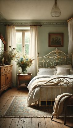 a bed sitting in a bedroom next to a window with curtains on the windowsill