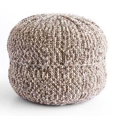 a brown and white tweed poufce sitting on top of a table