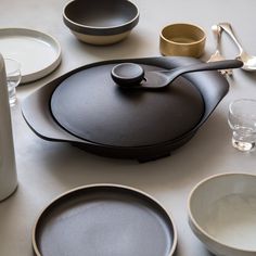 a table topped with black and white dishes