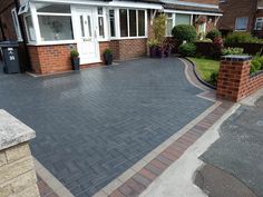 a brick driveway in front of a house