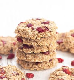 several oatmeal cookies stacked on top of each other with cranberries