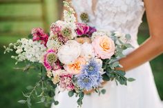 a woman holding a bouquet of flowers in her hands