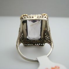 "For sale: (1) d840 14k White Gold Amethyst Seed Pearl Ring PLEASE READ ENTIRE DESCRIPTION BEFORE PURCHASING Pre-owned item. Good condition. Please see pictures for details. Sold as is, as seen on pictures. This ring contains one large amethyst and 41 seed pearls. It is not stamped, but has been tested for authenticity. Specifics: 14k White gold Size: 7 (U.S.) Stone Dimensions: 20 mm x 10 mm Width: 24.3 mm Total Weight: 6.9 grams Please be 100% sure of your purchase before buying, as we do not o Emerald Cut Gemstone Rings For Evening, Purple Baguette Cut Rings For Formal Occasions, Formal White Gold Topaz Ring With Rectangular Stone, Rectangular Platinum Ring For Formal Occasions, Luxury Emerald-cut Amethyst Ring For Formal Events, Luxury Emerald Cut Amethyst Ring For Formal Occasions, Rectangular Stone Ring Hallmarked For Anniversary, Hallmarked Rings With Rectangular Stone For Anniversary, White Sapphire Gemstone Ring For Formal Occasions