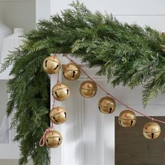 a christmas garland with bells hanging from it