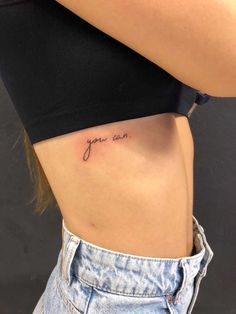 a woman's stomach with the word you can written on it, in cursive font