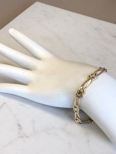 "14kt Yellow Gold Unisex Solid Open Link Bracelet 8\" in length. This unique and unusual Figaro pattern has a bright shiny plain polished finish, very flexible and comfortable to wear, a lobster claw clasp closure, 1/4\" wide all solid links and weighs 11.9 grams. This item would Retail for $1,789.00" Elegant Metal Bracelets With Figaro Chain, Modern Gold Figaro Chain Bracelet, Gold Sterling Silver Oval Link Bracelet, Gold Sterling Silver Oval Link Bracelet With Polished Finish, Formal Gold Paperclip Bracelet With Polished Finish, Gold Paperclip Bracelet With Polished Finish For Formal Occasions, Elegant Sterling Silver Bracelet With Figaro Chain, Formal Yellow Gold Paperclip Bracelet, Modern 14k Gold Bracelet With Figaro Chain