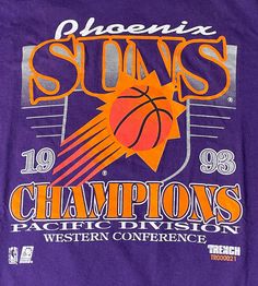 a purple shirt with an orange and white basketball on it that says suns champs pacific division western conference