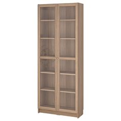 a tall wooden bookcase with glass doors