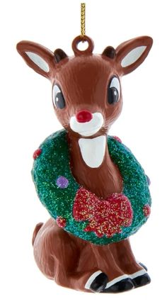 a christmas ornament with a deer wearing a wreath on it's back