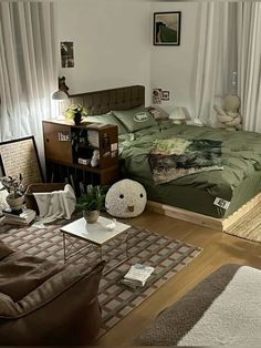 a bed room with a neatly made bed and lots of pillows on the floor next to a window