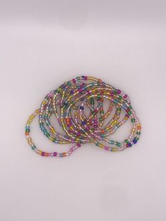 multicolored beaded bracelets on white background