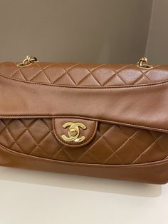 Chanel Vintage Quilted Cc Flap BagTan Brown Lambskin24K Gold Plated HardwareSize 23 x 13 x 6.5 cmSingle chain drop 42cmDouble chain drop 22 cm1 series8/10 Vintage  (minor vintage vintage sign. Well structured)Includes hologram intactPrice now 4200 sgd  3200 usd CN5907-03 Chanel Vintage, Chanel Black, Vintage Quilts, Vintage Chanel, Flap Bag, Vintage Signs, Tan Brown, Chanel Bag, Bottega Veneta