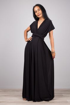 "Black Convertible Bridesmaid Dress, Infinity Event Gown Dress, Multiway Dress, Multi Wrap Halter Dress, Gala Evening dress, Black wedding guest dress PRODUCT SIZE : Free Size up size US 14 * Chest : Free * Waist : min 24\" up to 40\" * Length : 42\" from high waist to hem (measured when laying flat) MATERIAL : * Polyester spandex \" Venetia\" > soft and comfortable to wear OTHER COLOURS : https://www.etsy.com/listing/92030618 https://www.etsy.com/listing/1082250771 MODEL : * Model chest : 32\", Evening V-neck Faux Wrap Dress, Pre-draped Floor-length Bridesmaid Dress, Pre-draped Black Maxi Dress For Wedding, Draped Maxi Dress For Prom, Black V-neck Bridesmaid Dress, Fitted Draped Maxi Dress For Bridesmaid, Fitted Draped Bridesmaid Maxi Dress, Elegant Solid Color Wrap Dress For Party, Elegant Solid Color Party Wrap Dress