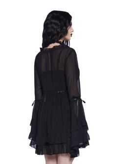 Be heavenly in this chiffon mini dress which has tiered bell sleeves, interlocking ribbon detailing, a ruffled trim, a plunging neckline, a cross charm on the front, and a tiered skirt. Dress With Bell Sleeves, Crochet Shop, Festival Shop, Chiffon Mini Dress, Pride Outfit, Black Doll, Bell Sleeve Dress, Cross Charms, Tiered Skirt