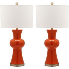 two orange lamps with white shades on them