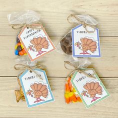 three bags filled with candy sitting on top of a wooden table