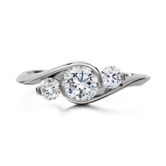 three stone diamond ring in white gold with diamonds on the sides and an elegant twist design