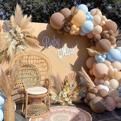 a baby shower with balloons and chairs in front of a sign that says mama on it