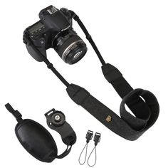 a camera with a strap attached to it's body and some other accessories around it