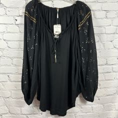 Free People Peasant Top 3/4 Sleeve Details Lace Up Tassel Tie V-Neck Black S Nwt A Beautiful Oversized Tunic-Length Top From Free People New With Tags. Tie Tassels For Lace Up Detailing At The Neckline. Gold Embellishments On The Sleeves And End Of Tassels. Lightweight And Flowy Silhouette That Is Sure To Become A Staple In Your Wardrobe. Condition: Nwt Brand: Free People Size: S Color: Black Material: 100% Rayon Approximate Measurements (Garment Laying Flat)- Pit To Pit: 23” Length: 28” Sleeve Black Long Sleeve Peasant Top For Fall, Long Sleeve Black Peasant Top For Fall, Fall Long Sleeve Tops With Tassel Ties, Black Peasant Top For Fall, Black Long Sleeve Tops With Tassels, Fall V-neck Blouse With Tassels, Black Long Sleeve Peasant Top For Festival, Black Bohemian Peasant Top For Fall, Fall Tassel V-neck Blouse