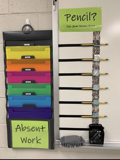 a bulletin board with colorful file drawers and pencils hanging on it's side