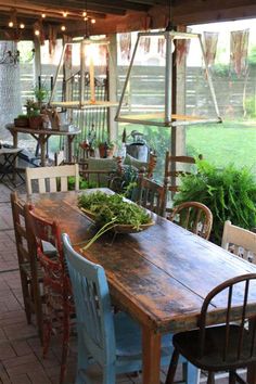 an outdoor dining area with wooden table and chairs