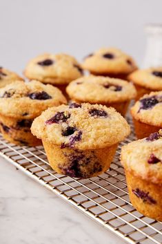 blueberry muffins on a cooling rack ready to be eaten by someone else