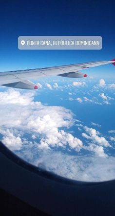 the wing of an airplane flying over clouds