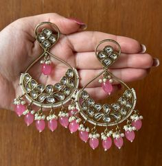 Beautiful and high quality Pink Kundan Earrings with gold detailing. These earrings add a Royal touch to any outfit. If you are looking for a pair of earrings that really make a statement, these are the ones for you!  In case of any queries, please feel free to contact us and we will be happy to assist you.  Happy shopping! Gold Dual-tone Kundan Earrings, Dual-tone Kundan Earrings For Gifts, Traditional Dual-tone Kundan Earrings, Dual-tone Earrings For Navratri Celebration, Temple Jewelry Chandbalis With Pierced Ears In Kundan, Dual-tone Chandbali Earrings For Festive Occasions, Bollywood Style Earrings For Navratri With Pierced Ears, Dual-tone Earrings For Diwali Celebration, Festive Dual-tone Bridal Earrings For Diwali