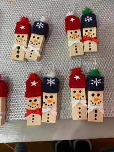 snowmen made out of wooden pegs on a table