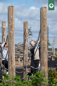 Child climbing along rope playground equipment